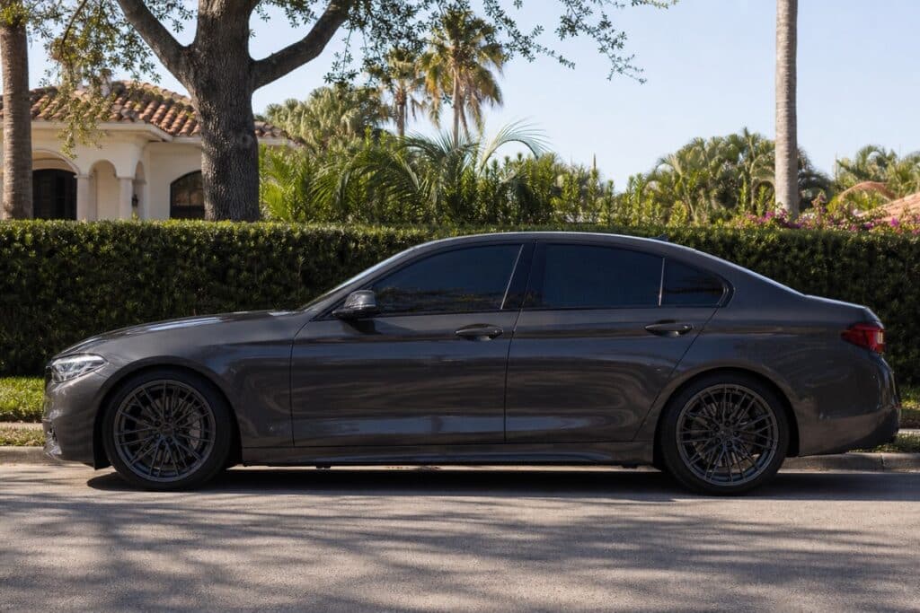 Parked car with dark tinted windows in bright Florida sun