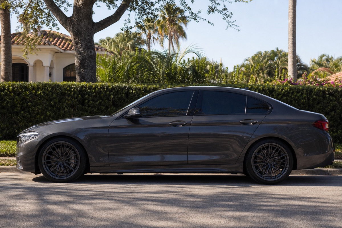 Parked car with dark tinted windows in bright Florida sun
