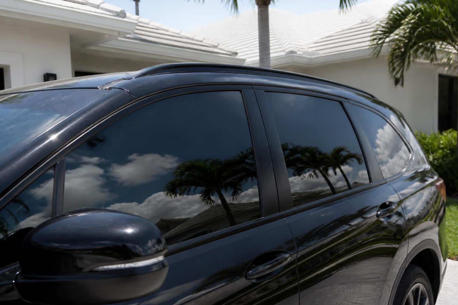Black SUV with freshly tinted windows in a Punta Gorda driveway