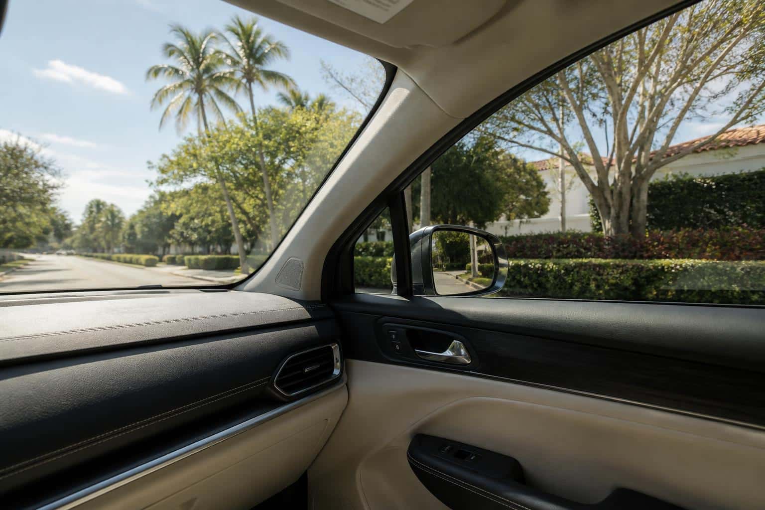 View from inside a tinted car looking out at a sunny Florida street