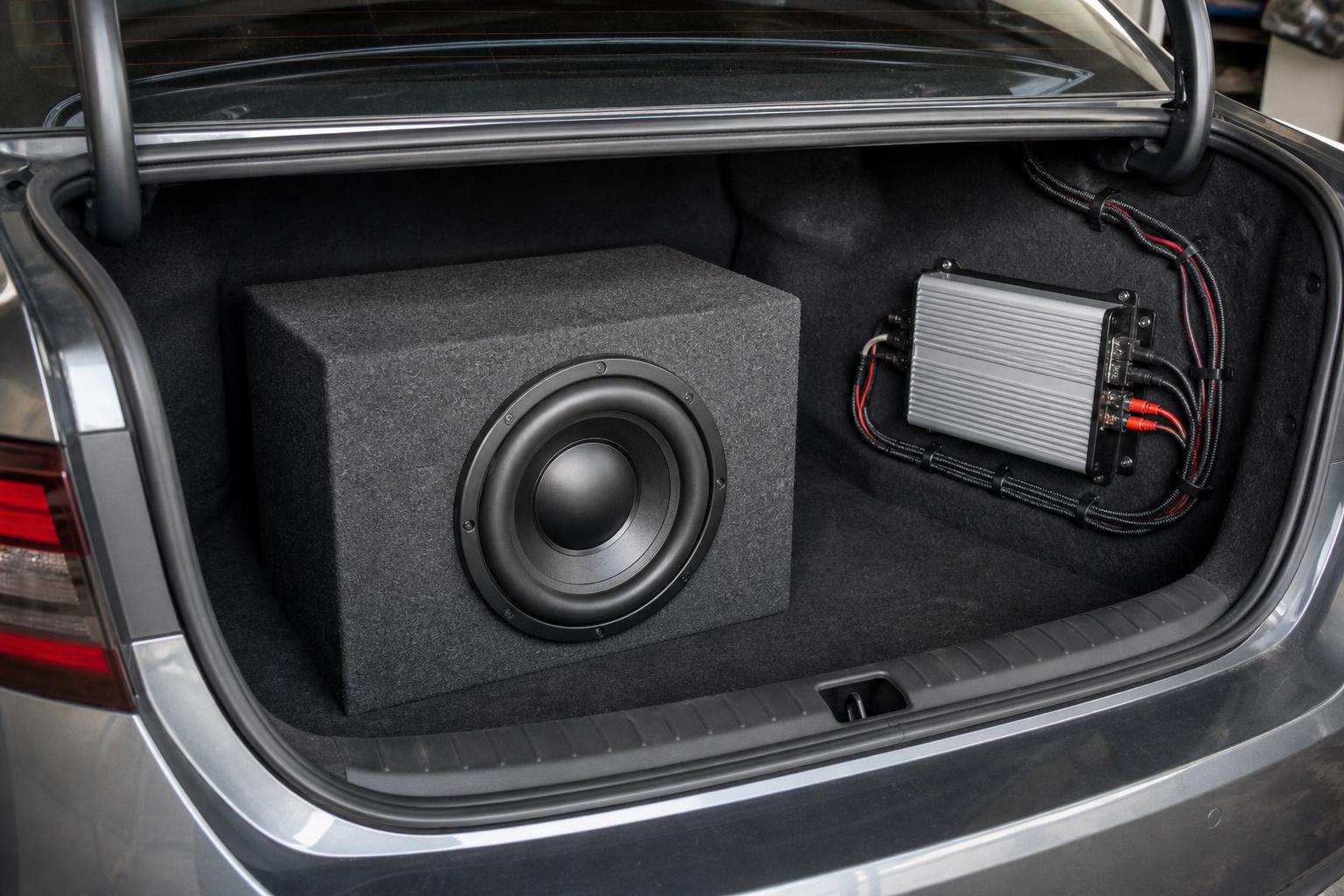 Subwoofer enclosure and amplifier installed in a car trunk