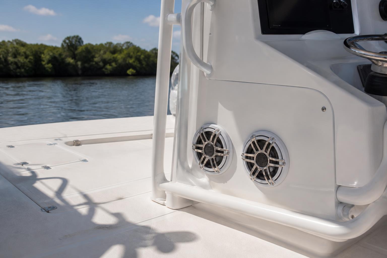 Two marine speakers mounted in the side console of a center-console boat