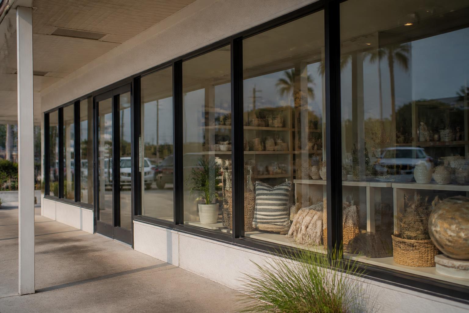 Small retail storefront with clear display windows in afternoon light